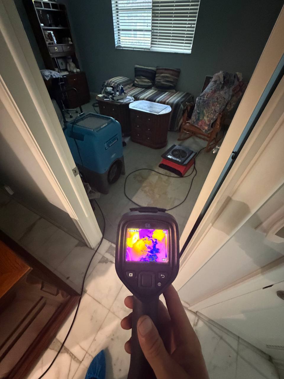Thermal camera inspection detecting hidden moisture migration in adjacent room