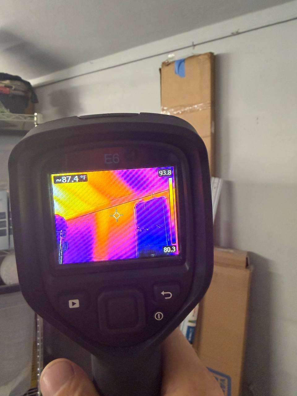 Thermal imaging camera detecting temperature anomalies and hidden moisture migration behind wall