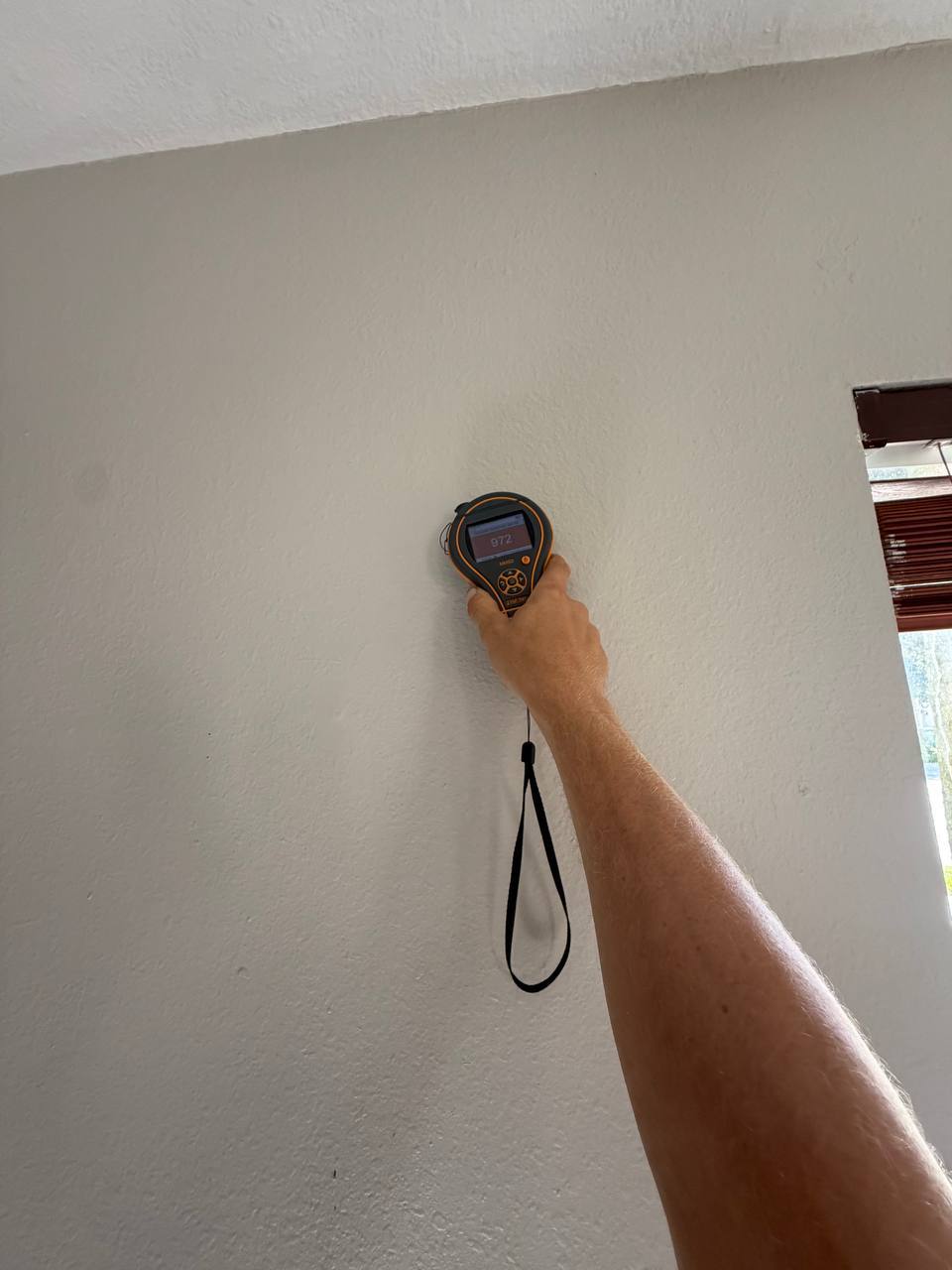 Evaluating main living space exterior walls and window frames for moisture leaks