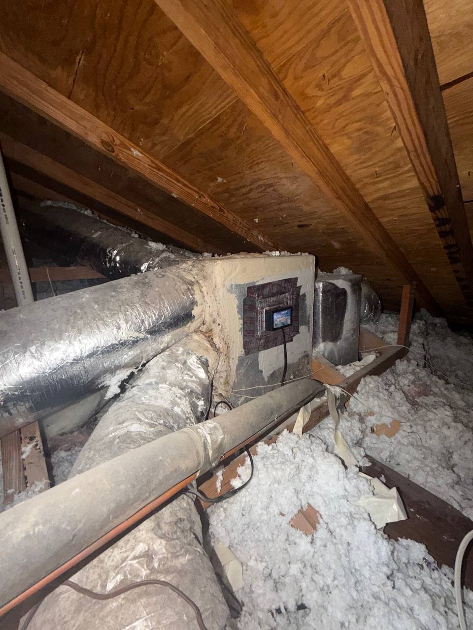 Inspecting attic HVAC plenum box and flexible ductwork for condensation buildup