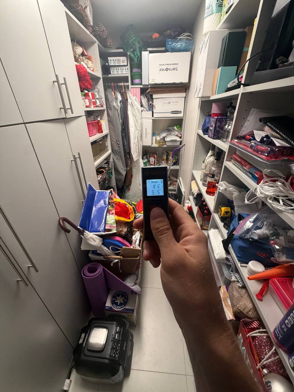 Measuring closet space dimensions during indoor air quality and mold investigation