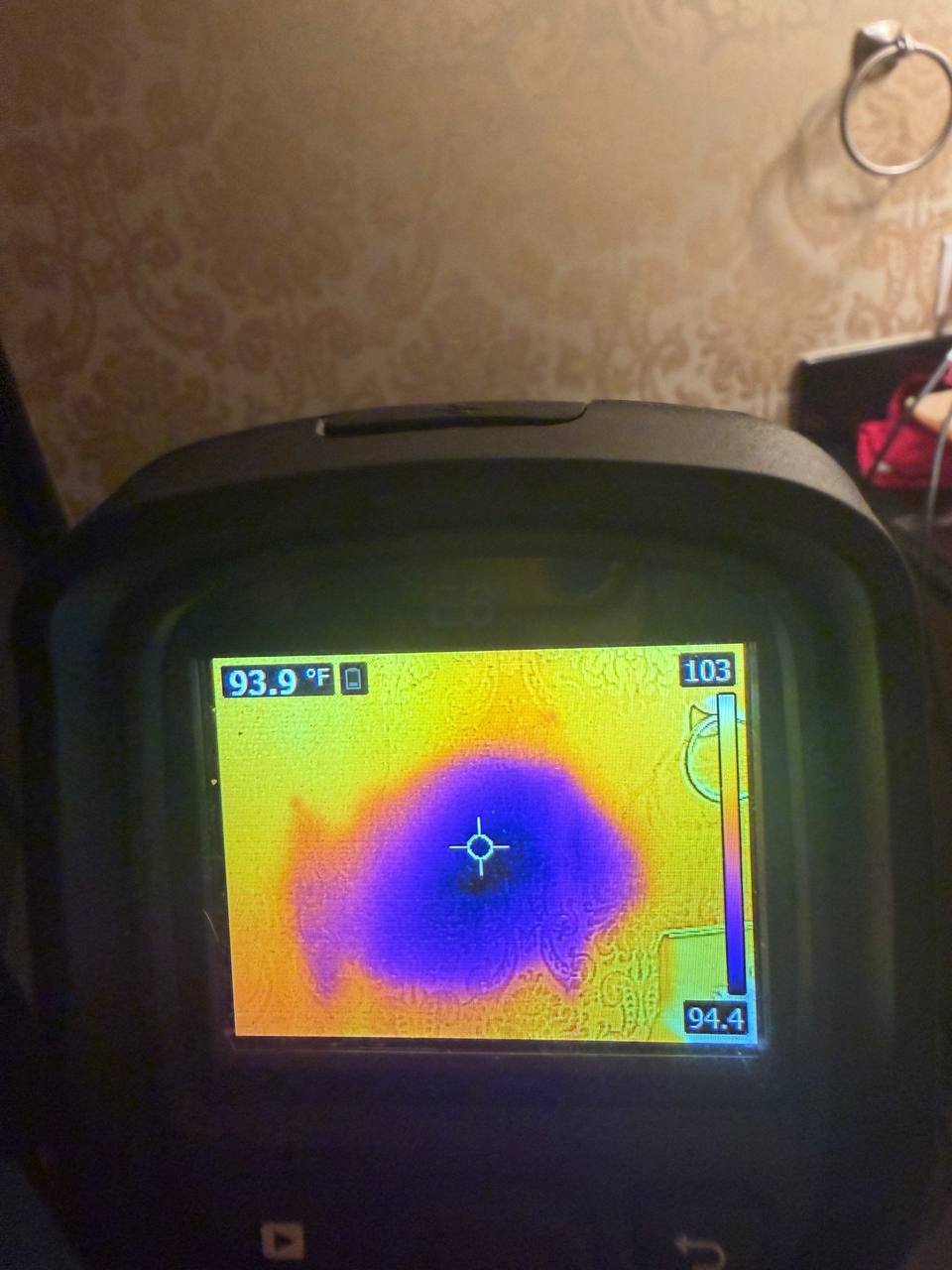 FLIR thermal camera detecting cold moisture footprint behind wall covering