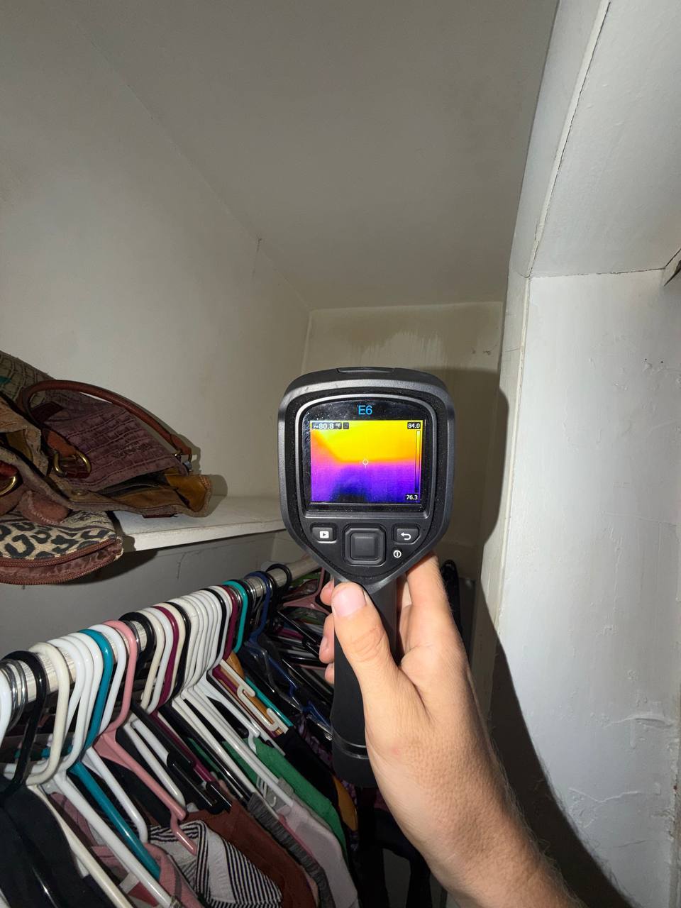 FLIR thermal camera detecting cold thermal anomalies along closet wall