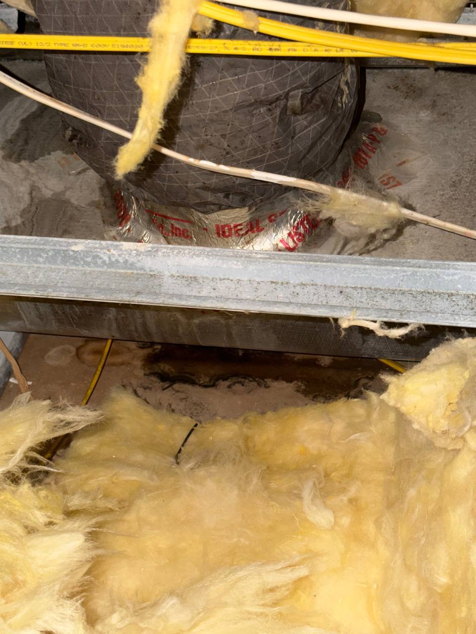 Moisture accumulation and insulation degradation underneath HVAC ducting in attic crawlspace