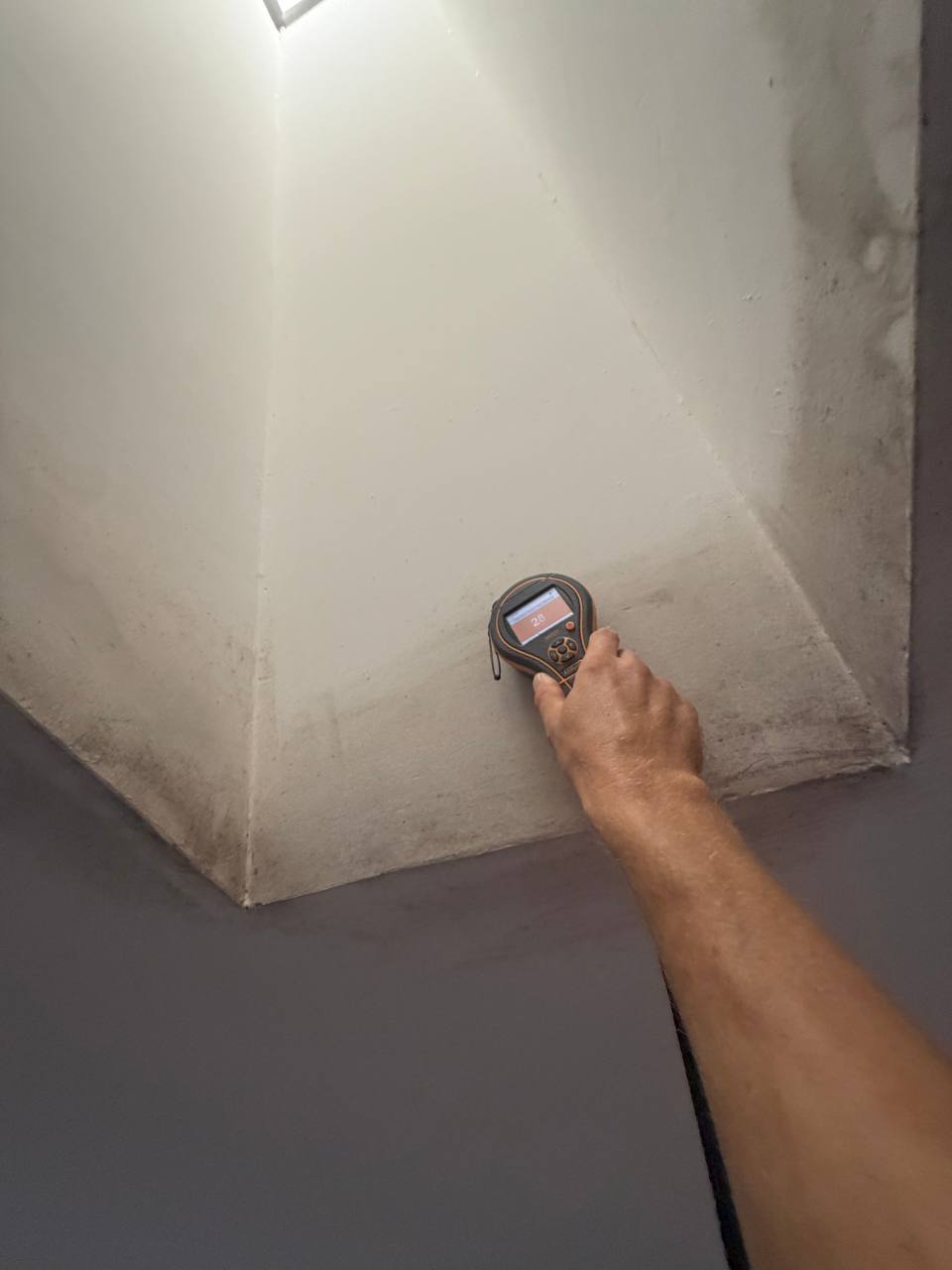 Measuring moisture content in ceiling skylight shaft with Protimeter meter in Miramar