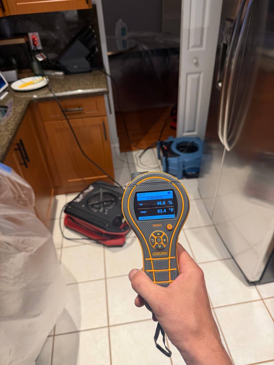 Protimeter measuring relative humidity and ambient temperature during water damage drying