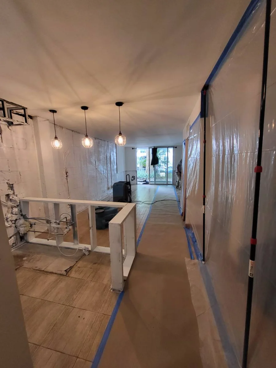 Removal of water-damaged materials and antimicrobial treatment