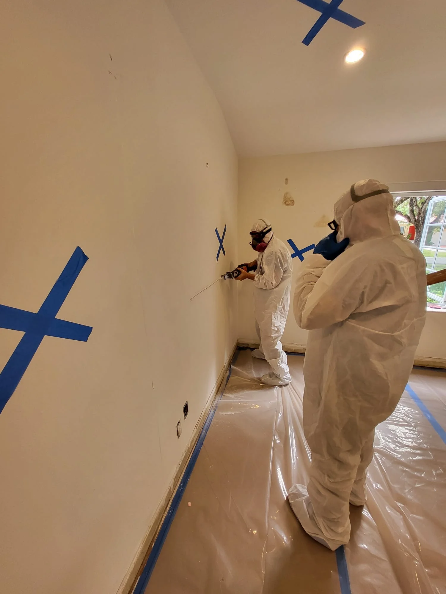 Mold remediation crew removing affected materials during demolition